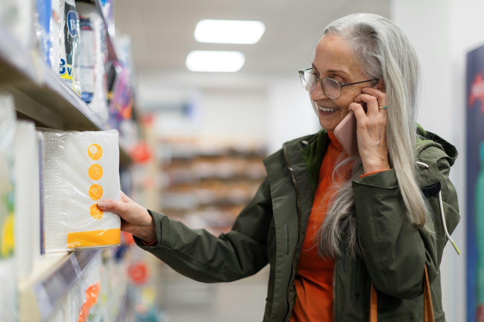 Older woman on the phone in a shop