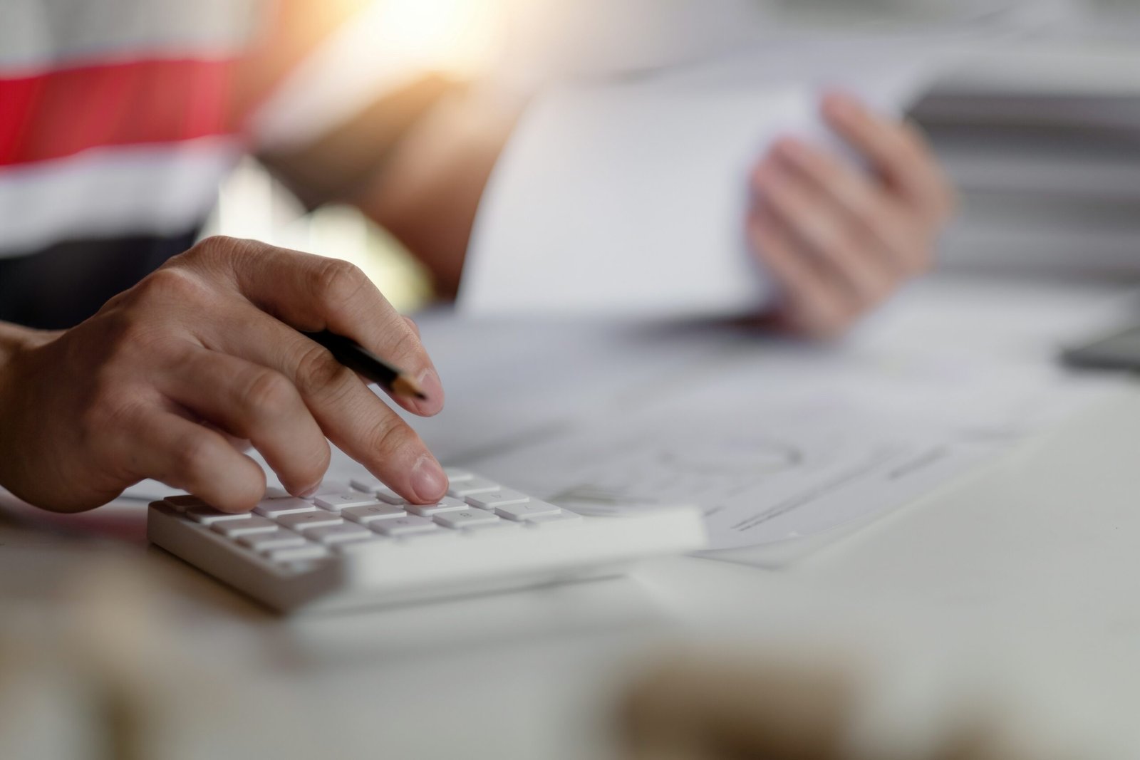 Woman cclauylating her pension on a calculator