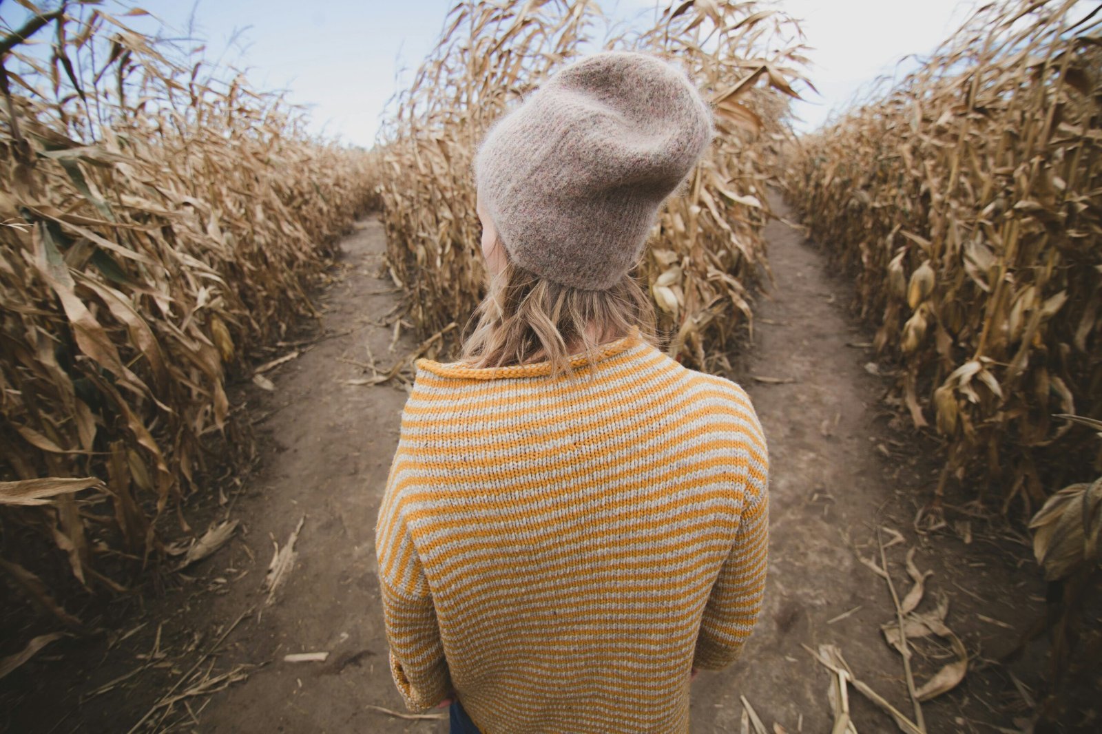 Woman standing in a field with a choice to make